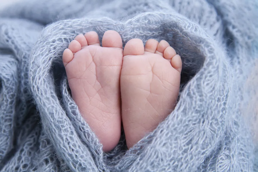 A baby's foot on a blanket