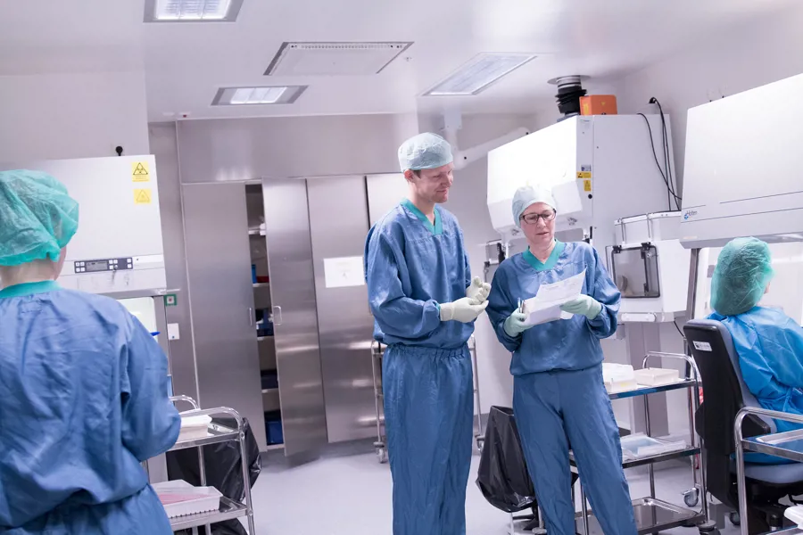 A group of people in surgical scrubs in a room