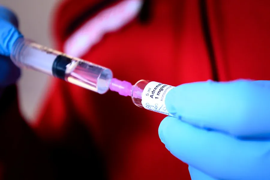 A person holding a syringe