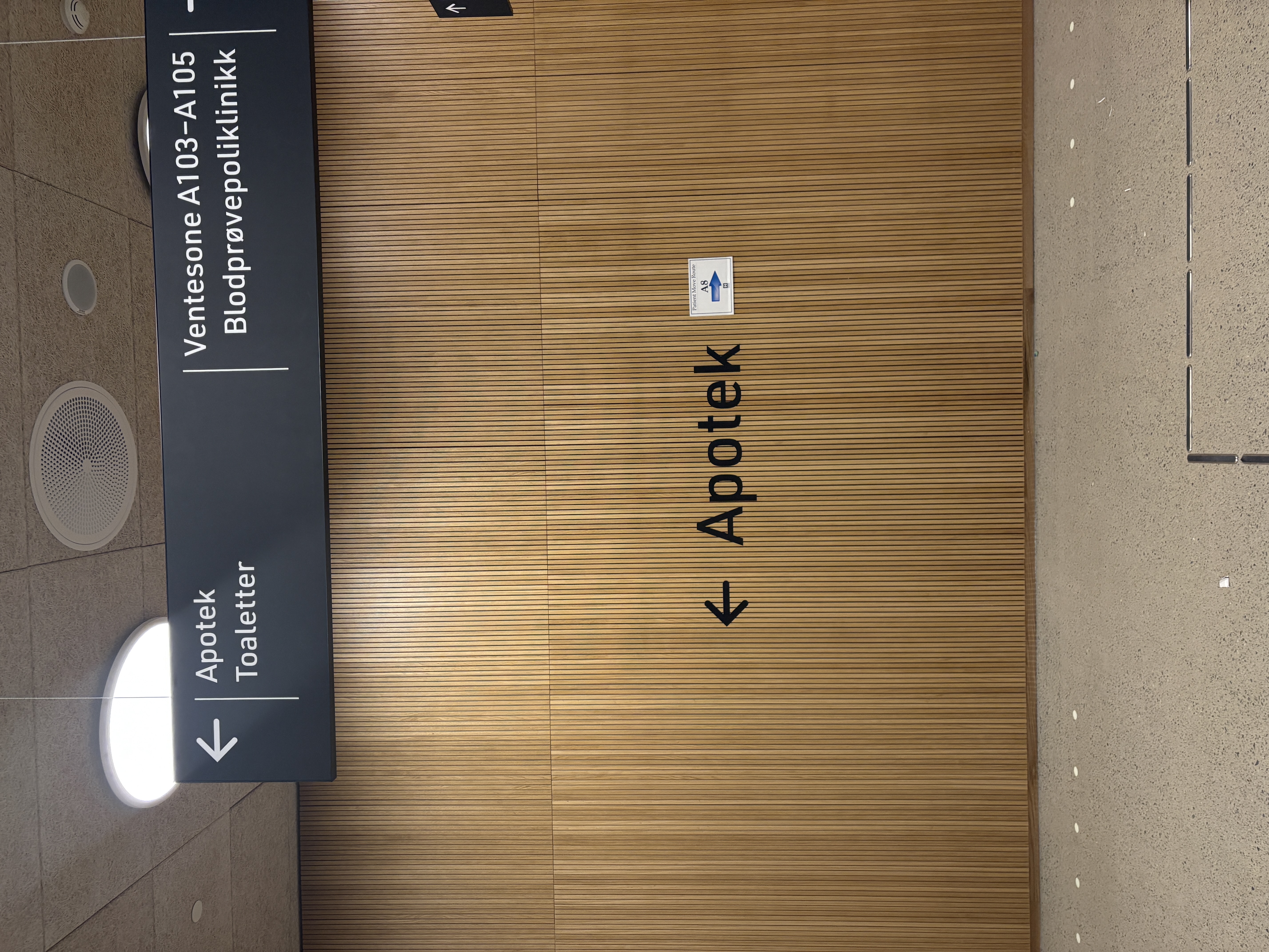 Skilt til apoteket på spilevegg av eik.